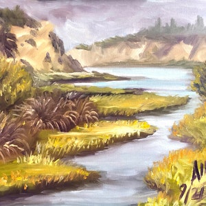 May include: A painting of a river winding through a grassy marsh with a distant view of a hillside and trees. The sky is a muted gray, and the water is a light blue. The painting is signed "Ainsa 9/23"