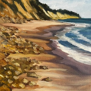 Puede incluir: Una pintura de una playa de arena con una costa rocosa y un océano azul en el fondo. El cielo es azul con nubes blancas. La pintura está firmada "Ainsa 1924" en la esquina inferior derecha.