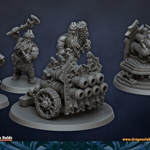 May include: A grey resin miniature set featuring an organ gun artillery piece on a circular base, accompanied by two standing dwarf figures. One dwarf holds a wrench, while the other carries a cluster of spherical bombs. The set includes detailed mechanical components and ornate gear-like wheels.