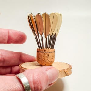 Miniature badminton shuttlecock for enthusiasts and athletes on a wooden base, handcrafted sports decoration