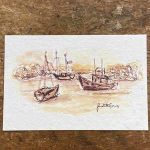 May include: A sepia-toned watercolor painting of boats in a harbor. The artwork features three boats with masts and a small fishing boat. The artist's signature, "Judith Gray," is visible in the lower right corner.