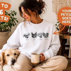 May include: A white crewneck sweatshirt featuring four black line-art pet portraits across the chest, each with a name printed underneath. The text "UP TO 6 PETS!" and "YOUR PET(S) GOES HERE" with an arrow pointing to the design are visible.