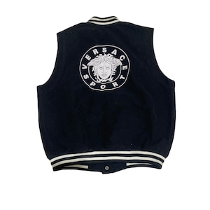 May include: Black sleeveless varsity jacket with a white embroidered Versace Sport logo on the back. The logo features a white Medusa head inside a circle.