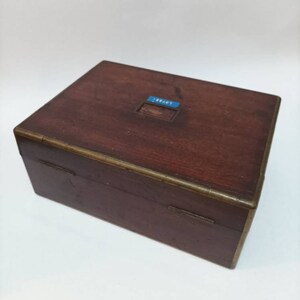 May include: A wooden box with a brass trim and a blue label that says "18847".