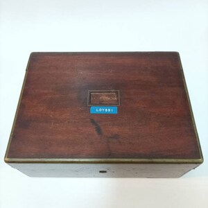 May include: A wooden box with a brass trim and a label that says "LOYSS1".