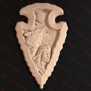 May include: A wooden carving of a Native American man and a wolf howling at the moon. The carving is in the shape of an arrowhead.