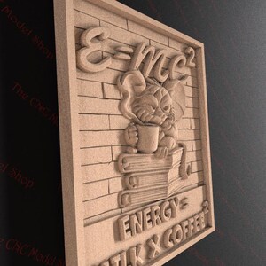 May include: A light brown wooden wall art piece featuring a carved design. The design includes the equation E=mc&sup2;, a cartoon character holding a mug, and the words "ENERGY, MILK & COFFEE&sup2;". The background has a brick pattern.