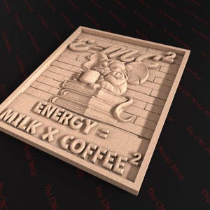 May include: A rectangular wooden plaque with a carved design. The design features a sleeping figure with a cup, books, and the text "ENERGY = MILK X COFFEE&sup2;". The plaque has a brick-like background and a framed border.