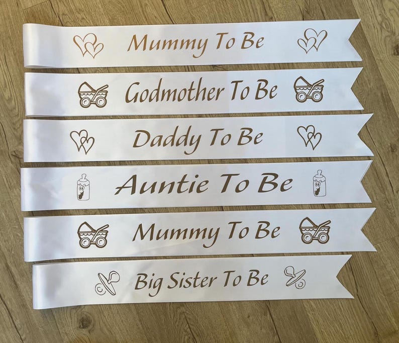 Baby Shower Sash, Mummy To be Sash, Custom sash White sash with gold text. Picture of footprint, Hearts, dummy, Pram, Bottle, Stolk. Personalsised with any wording. Nanny To be, Daddy To Be Big Sister To Be Auntie To Be