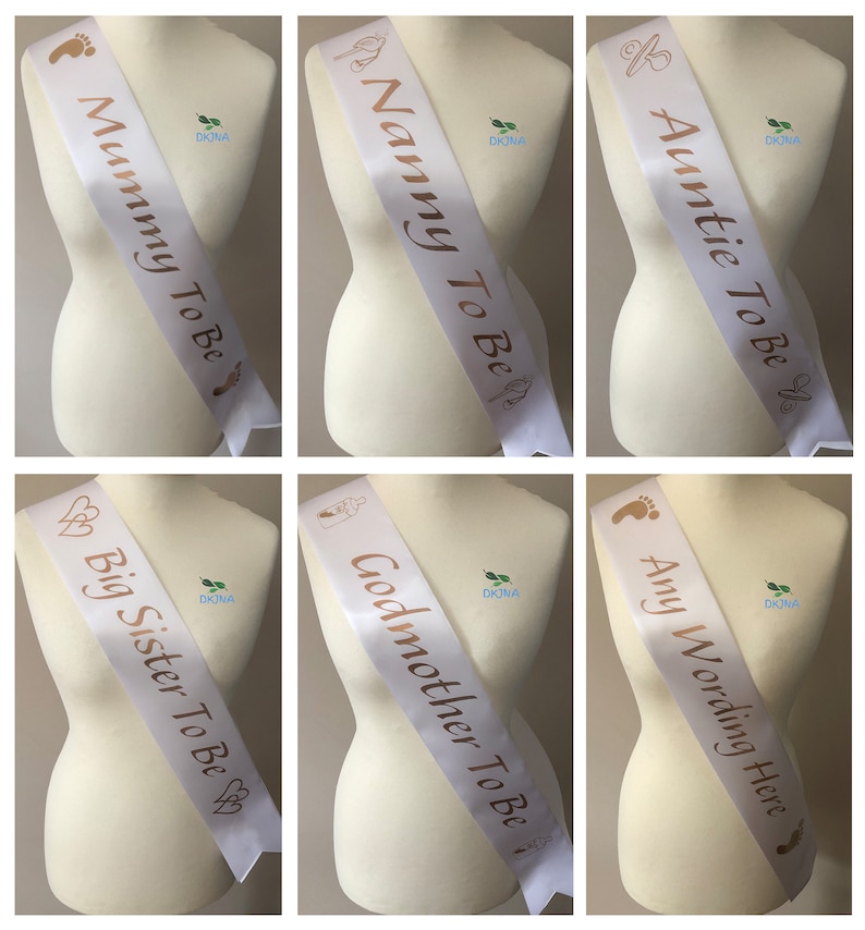 May include: Six white satin sashes with gold lettering. The sashes read "Mummy To Be", "Nanny To Be", "Auntie To Be", "Big Sister To Be", "Godmother To Be", and "Any Wording Here".