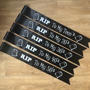 May include: Black satin sashes with white text and tombstone graphics. Each sash reads "RIP" followed by "To My Teen's", "To My 20's", "To My 30's", "To My 40's", and "To My 50's".