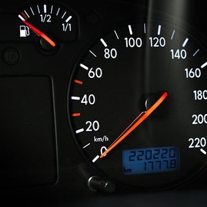 May include: A black car dashboard with a speedometer reading 220220 km. The speedometer needle is pointing to 160, and the digital display shows 177.8 km. The dashboard also includes a fuel gauge and a temperature gauge.