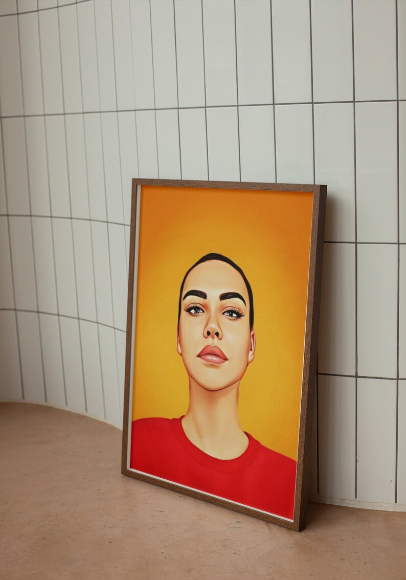 K&ouml;nnte beinhalten: Eine gerahmte Illustration einer Person mit kurzen, dunklen Haaren. Die Person blickt nach oben mit einem neutralen Ausdruck. Sie tr&auml;gt ein rotes Shirt vor einem gelben Hintergrund.