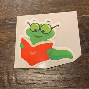 Adorable bookworm sticker . Vinyl, waterproof,removable great for water bottles and laptops.