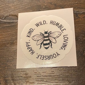 Bee wild, Bee kind, etc sticker. Vinyl, waterproof,removable great for water bottles and laptops.  Measures 2 x 2.