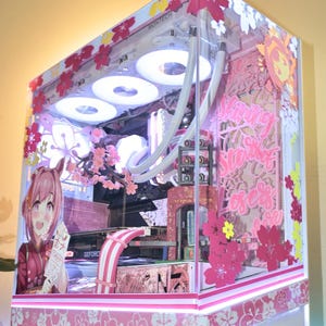 May include: A custom computer case featuring a pink and white cherry blossom theme with anime character decals, internal LED lighting, white cooling fans, and the text Shining Stars of Losers Rise printed on the side panel glass.