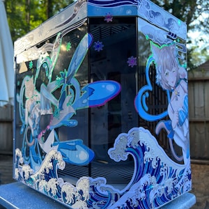 May include: A custom computer case with a blue and white anime-style design. The case features a wave pattern, anime characters, and snowflake accents. The case is rectangular and has a glass side panel.