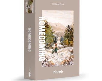 May include: A 500-piece puzzle box with the word "Homecoming" in white on a tan background. The puzzle image depicts a snowy landscape with trees, a fence, and a person walking on a path. The brand name "Pieceely" is at the bottom.