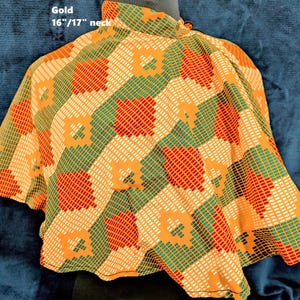 Puede incluir: Una blusa dorada con un estampado geom&eacute;trico en naranja, rojo, verde y blanco. La blusa tiene cuello alto y mangas cortas. El texto "Gold 16"/17" neck" es visible.