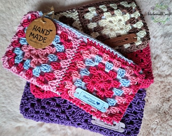 May include: Three crocheted pouches in different colors and patterns. The top pouch is pink, blue, and white with a brown tag that says "Hand Made Especially For You". The middle pouch is brown and white with a brown leather tag that says "Hand Made with Love". The bottom pouch is purple with a white leather tag that says "Hand Made with Love".