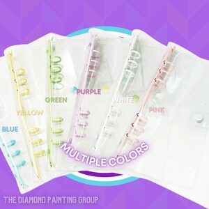 May include: Five clear plastic binders with different colored rings. The rings are yellow, green, purple, white, and pink. The binders have the text "MULTIPLE COLORS" printed on them.