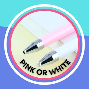 May include: Two pens, one pink and one white, with silver accents. The text "PINK OR WHITE" is written below the pens.