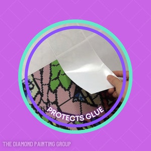 May include: A close-up of a white protective sheet being peeled back from a diamond painting canvas. The canvas has a colorful design and the text "Protects Glue" is visible.
