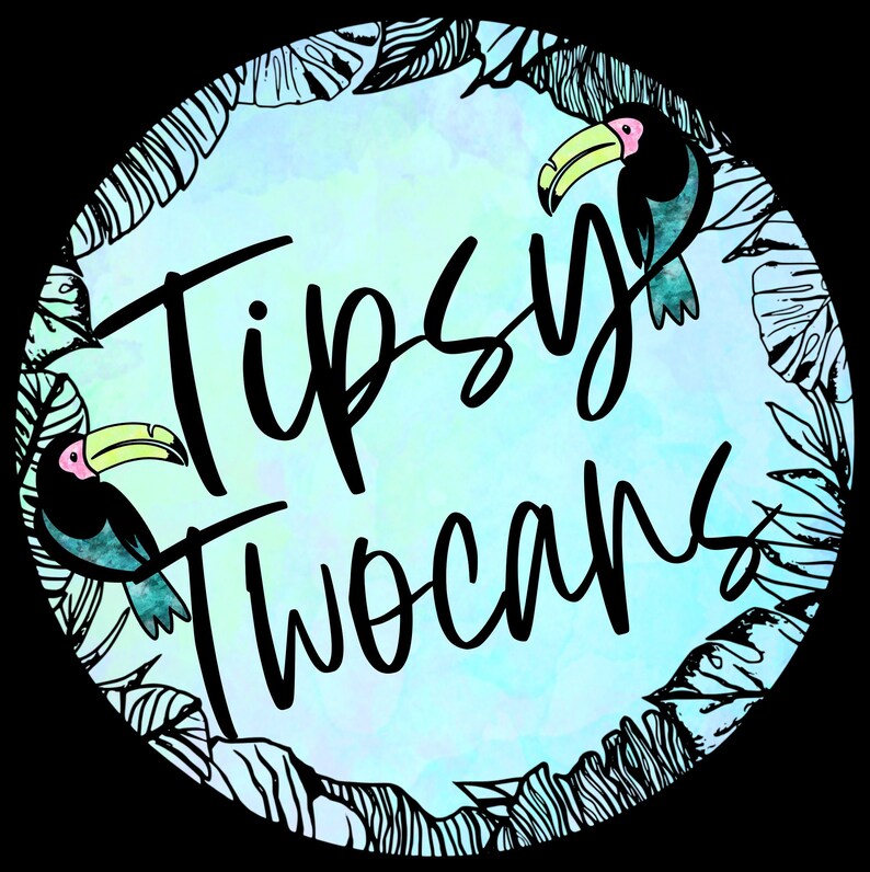 May include: A circular design with a watercolor background in shades of blue and green. The text "Tipsy Two Cans" is written in black cursive font. Two toucans with pink beaks and black bodies are on either side of the text.