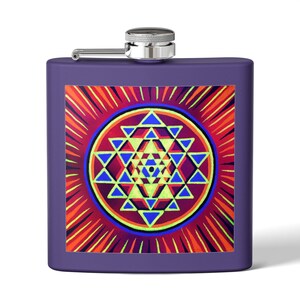May include: A purple metal flask featuring a square graphic print of a Sri Yantra geometric pattern. The design consists of interlocking triangles in shades of blue, yellow, and red, surrounded by a sunburst motif. It has a silver screw-top cap.