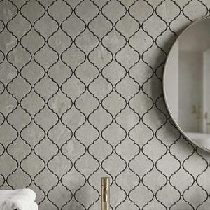 May include: A white ceramic mug with a black handle and the text "But First, Coffee" in a bold, black font. The mug is set against a blurred background, suggesting a cosy setting.