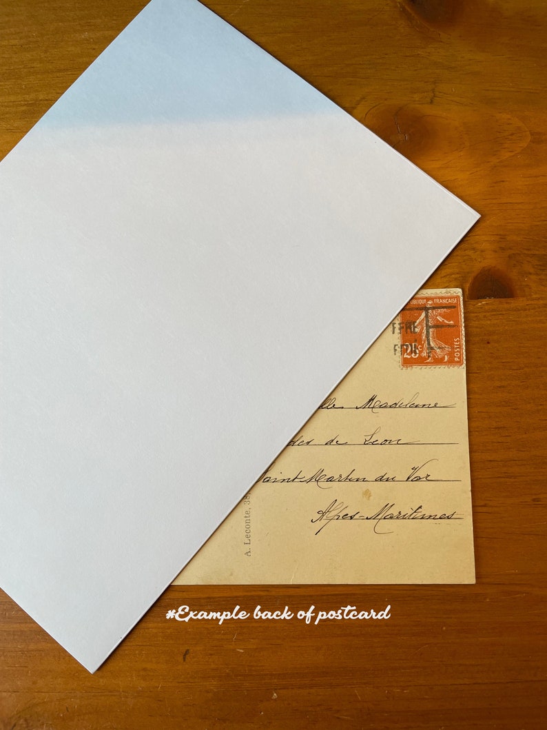 May include: The back of a vintage postcard with handwritten text in French. The text reads "Mesnilens, Place de l'Ecore, Point Martin du Vor, Ares-Martines". A French postage stamp is in the upper right corner.