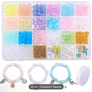 May include: A clear plastic storage box filled with colorful beads, including gold, white, pink, blue, and clear. The box also includes small charms and a spool of string. The text "Style: Gradient Beads" is printed below the box.