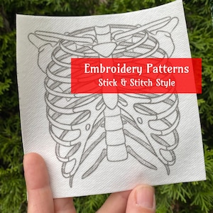 May include: A white sheet of paper with a gray line drawing of a rib cage. The paper has the text "Embroidery Patterns Stick & Stitch Style" printed in red.