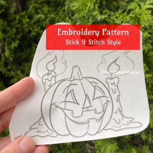 May include: A black and white embroidery pattern of a jack-o'-lantern with a candle on each side. The pattern is labeled "Embroidery Pattern Stick & Stitch Style" and "@horrorpopdesigns".