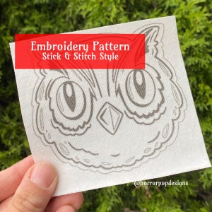 May include: A white square with a gray owl embroidery pattern. The text "Embroidery Pattern Stick & Stitch Style" is in a red rectangle. The design features large eyes and a diamond shape.