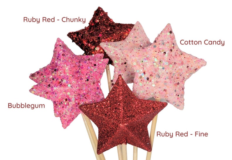 May include: Five glitter star-shaped ornaments on wooden sticks. The stars are in four colors: ruby red (chunky and fine), bubblegum pink, and cotton candy pink.