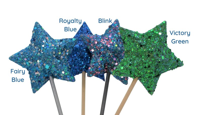 May include: Four glitter star wands with wooden sticks. The stars are in the colors: fairy blue, royalty blue, blink, and victory green.
