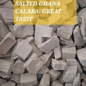 May include: A close-up image of a pile of light grey, irregularly shaped, broken pieces of rock. The text "SALTED GHANA CALABA. GREAT TASTE" is written in yellow on a rectangular yellow background.