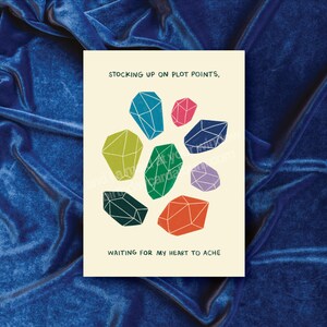 Puede incluir: Una ilustración colorida de formas geométricas que se asemejan a piedras preciosas con el texto "Stocking up on plot points, waiting for my heart to ache".