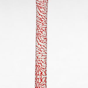 May include: A long, cylindrical golf club head cover featuring a white base with a vibrant red elephant print pattern. The cover is straight and narrow, designed to protect the shaft and head of a golf club, with a clean, uniform finish throughout.