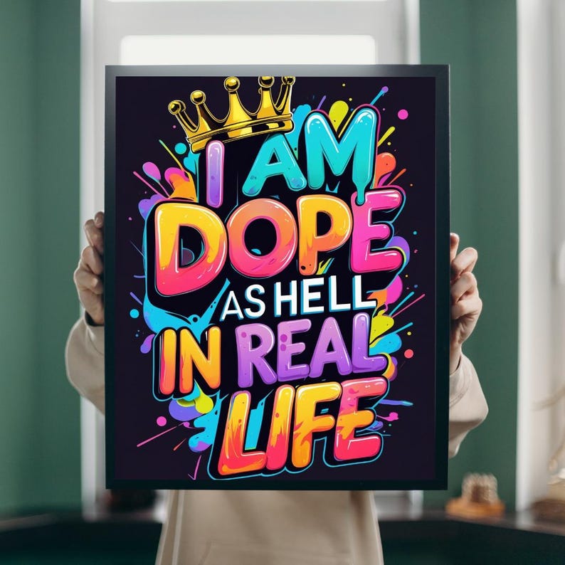 May include: A framed art print with the words "I AM DOPE AS HELL IN REAL LIFE" in vibrant colors. The text is in a bold, graffiti-style font, with a gold crown above the word "AM". The background is black.