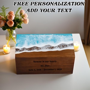 May include: A wooden box with a blue and white resin ocean wave design. The box has a personalized inscription that reads "forever in our hearts mr. jhon June 2, 1949 - December 1, 2023".