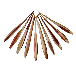 May include: A set of ten wooden crochet hooks with a natural wood and red wood finish. The hooks are arranged in a fan shape.