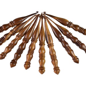 May include: Set of ten wooden crochet hooks in various sizes, ranging from 3.5 mm to 10.0 mm. The hooks are made of dark brown wood with a natural grain pattern.