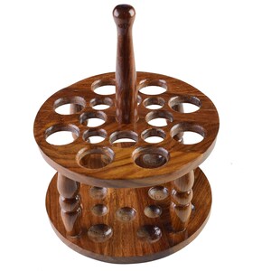 May include: A wooden stand with a central post and two tiers of circular holes, designed to hold a collection of items like paintbrushes or tools.