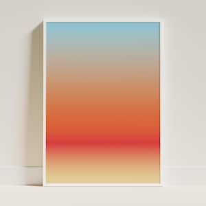 Könnte beinhalten: Ein gerahmter Kunstdruck mit einem Farbverlauf. Der obere Teil wechselt von Hellblau zu Orange, mit einem roten Band in der Mitte und einem Übergang zu Gelb am unteren Rand. Das Kunstwerk ist in einem weißen Rahmen eingefasst.