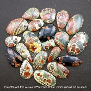 May include: A collection of 18 oval and teardrop shaped, polished, natural gemstone cabochons. The stones are a mix of green, brown, black, and red with a speckled and marbled pattern.