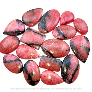 May include: A collection of 15 pink and black gemstone cabochons. The cabochons are various shapes and sizes, including oval, teardrop, and rectangular. The stones have a pink and black marbled pattern.