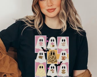 Könnte beinhalten: Schwarzes T-Shirt mit einem Raster von neun Cartoon-Geistern, jeder mit einem anderen Design, wie Kaffeetassen und Gebäck. Das Wort "FANTASMAS" ist in einer farbenfrohen, verspielten Schriftart unten aufgedruckt. Die Geister sind vor einem rosa Hintergrund.