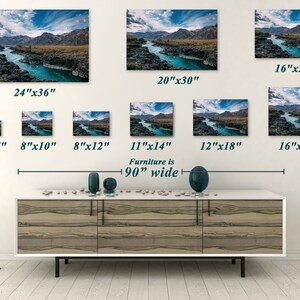 May include: Various sizes of landscape art prints featuring a turquoise river winding through a rocky canyon under a blue sky with clouds. Sizes range from 5"x7" to 24"x36". The furniture below is 90 inches wide.